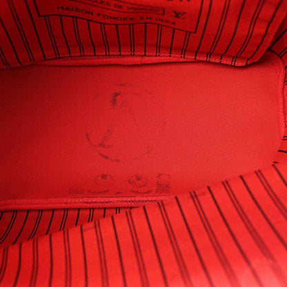 Red fabric lining with embossed monogram pattern inside the bag