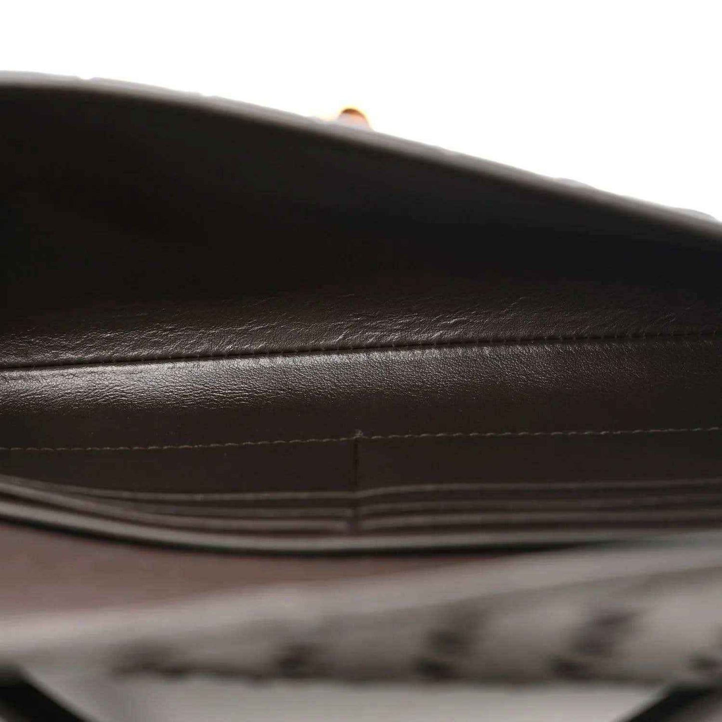 Nappa leather clutch interior with stitched seam and dark lining
