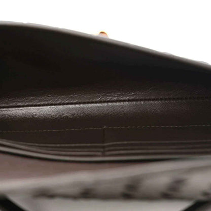 Nappa leather clutch interior with stitched seam and dark lining