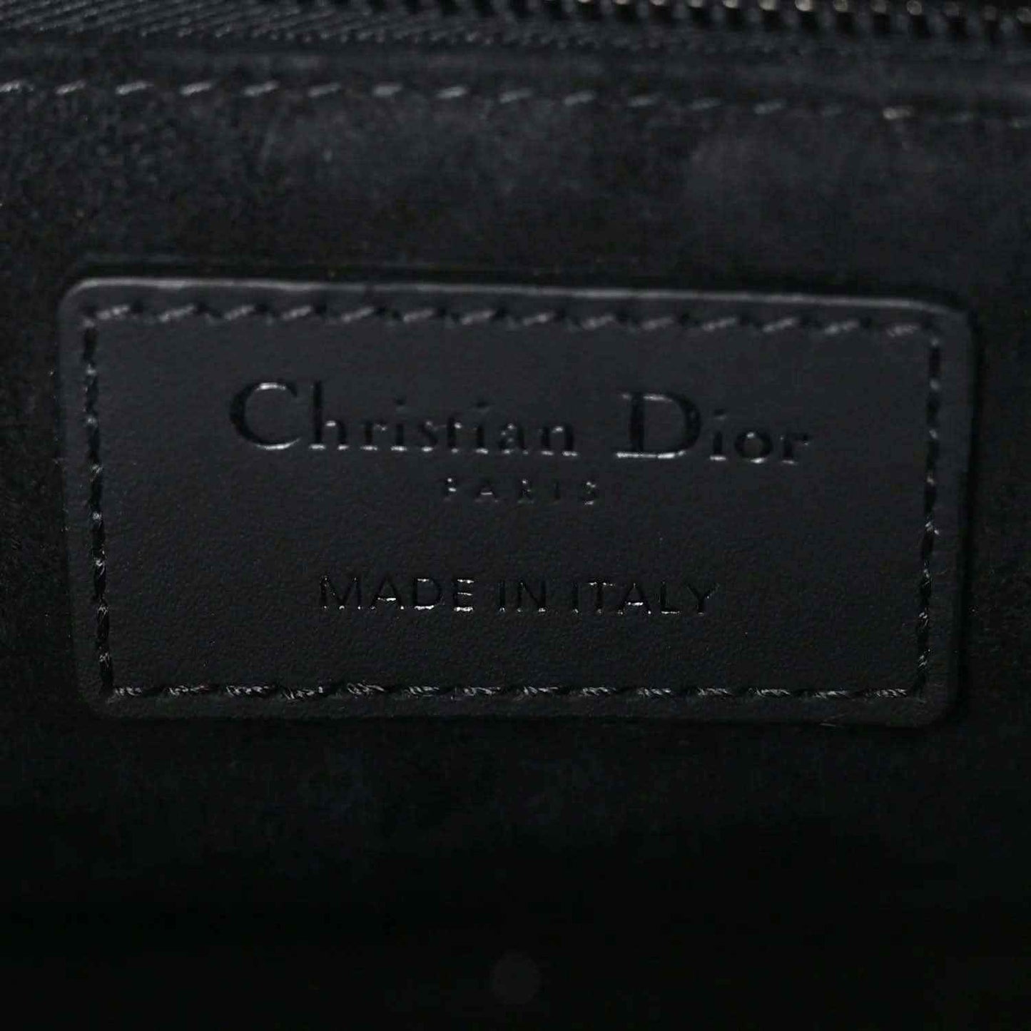 Christian Dior leather handbag label reading “MADE IN ITALY”