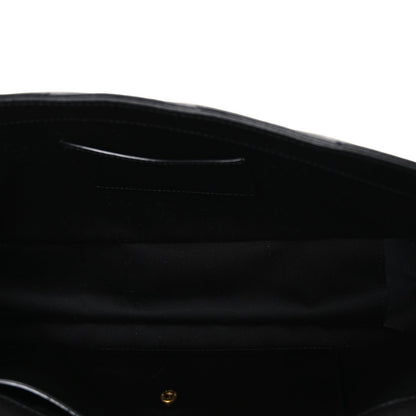 Black leather shoulder bag interior with stitched trim and small gold hardware