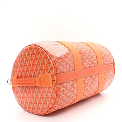 Orange monogram canvas barrel sports bag with snap tab and contrasting strap panel.