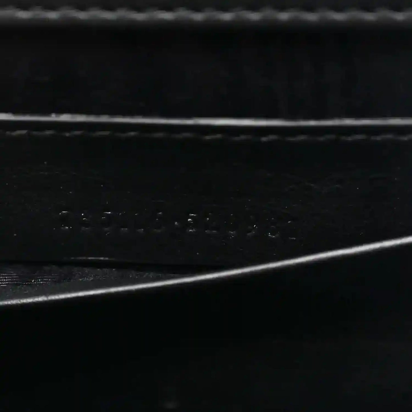 Close-up of black interior lining texture with subtle embossed details