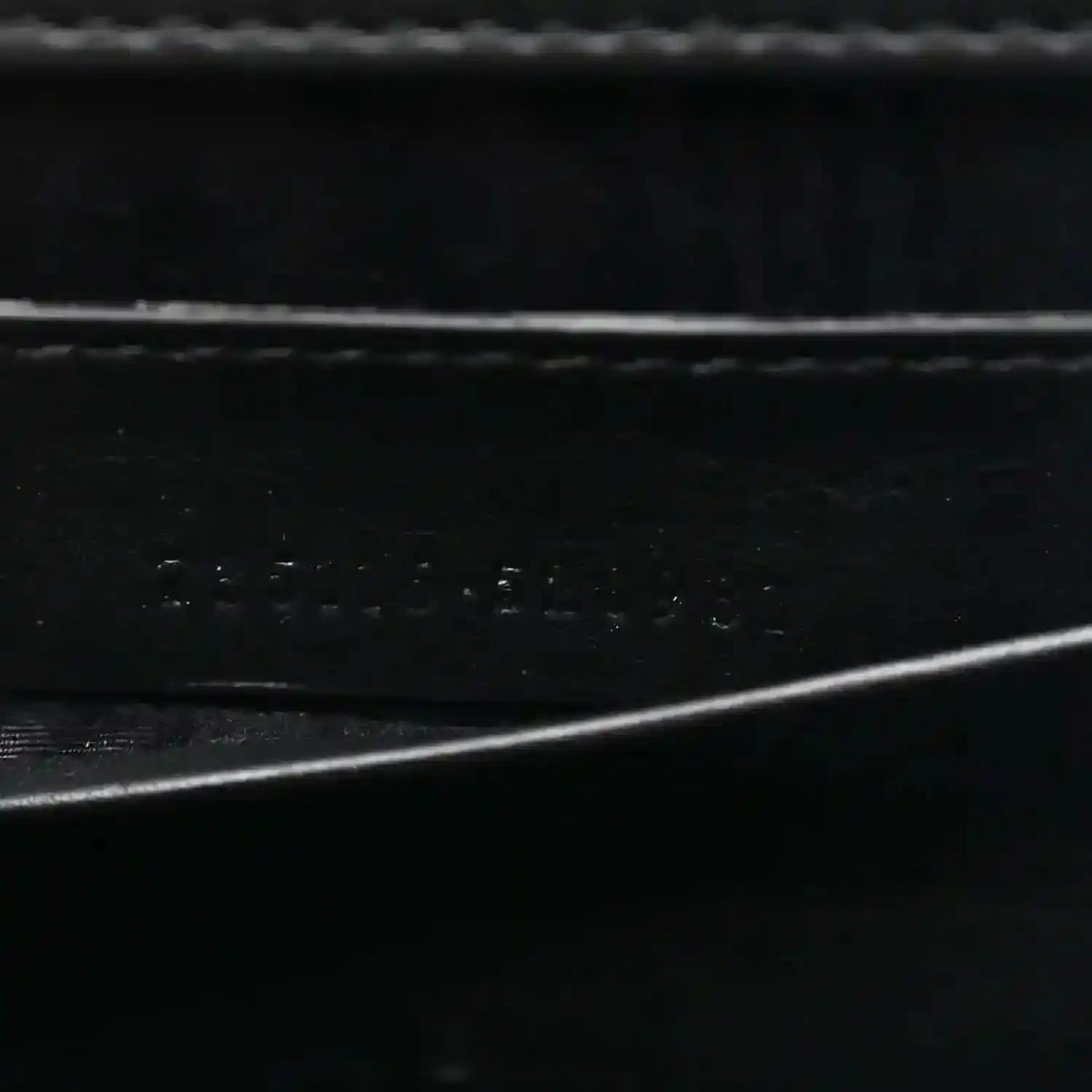 Close-up of black interior lining texture with subtle embossed details