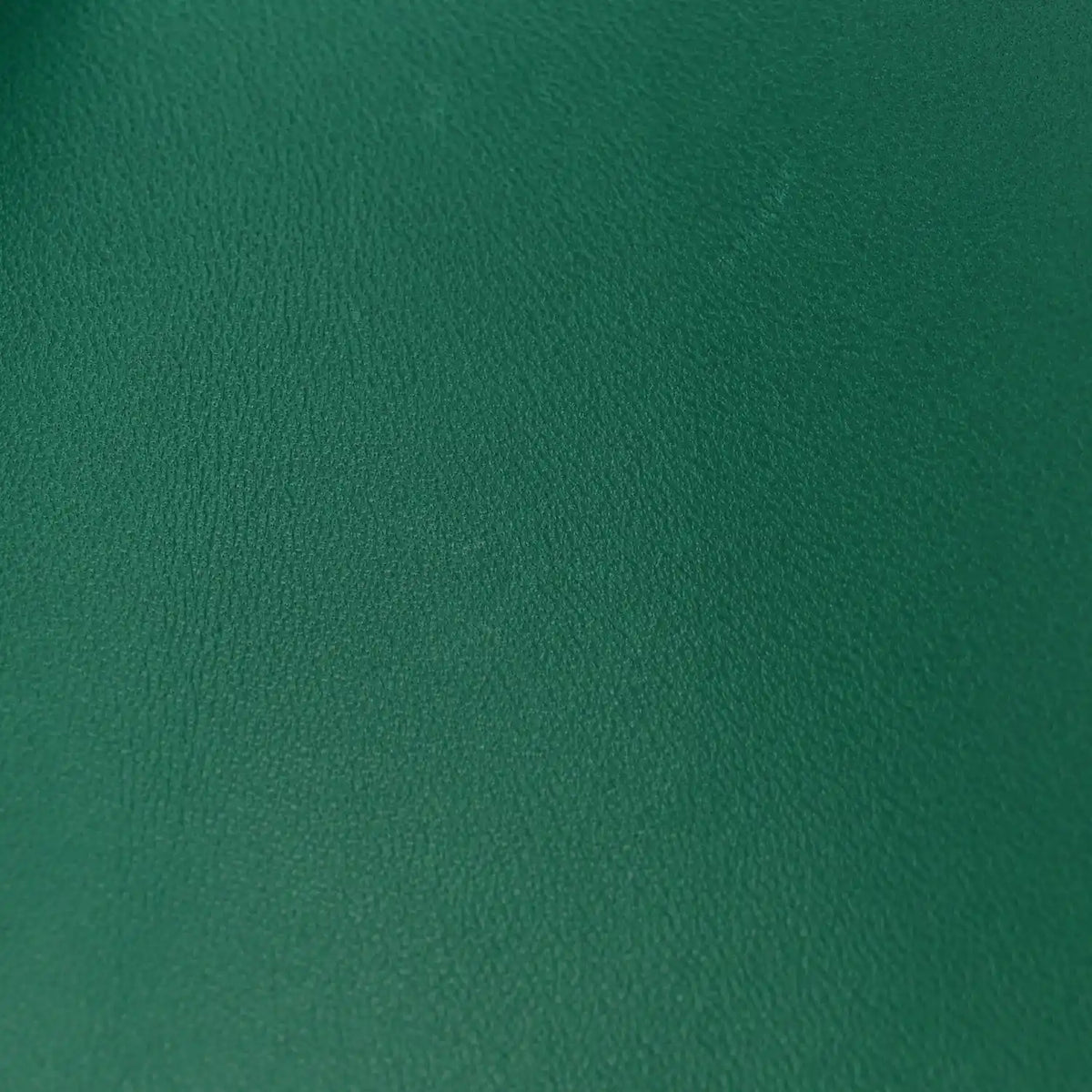 Green leather surface with pebbled grain texture