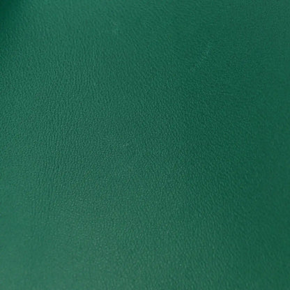 Green leather surface with pebbled grain texture