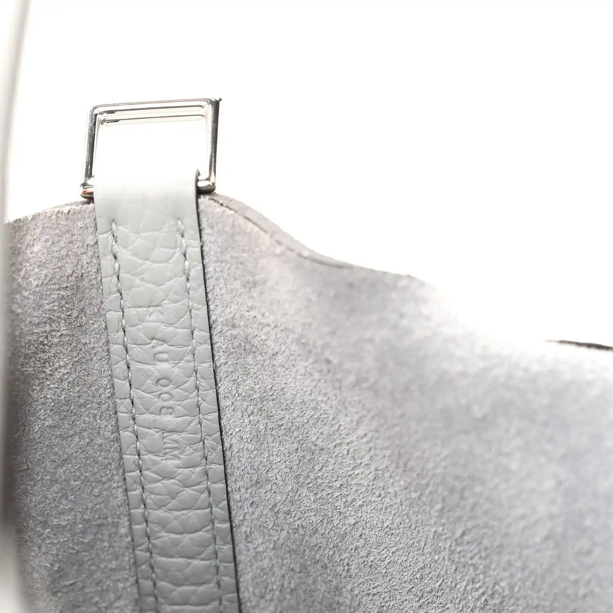 Light blue pebbled leather handle strap with metal buckle detail