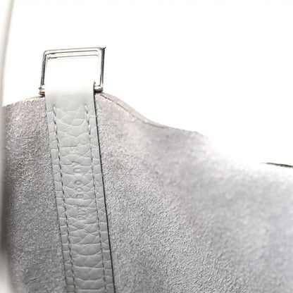 Light blue pebbled leather handle strap with metal buckle detail