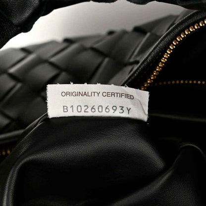 Black leather bag with gold zipper and “ORIGINALITY CERTIFIED” label