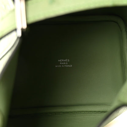 Green leather handbag interior panel with stitched seam and embossed logo text