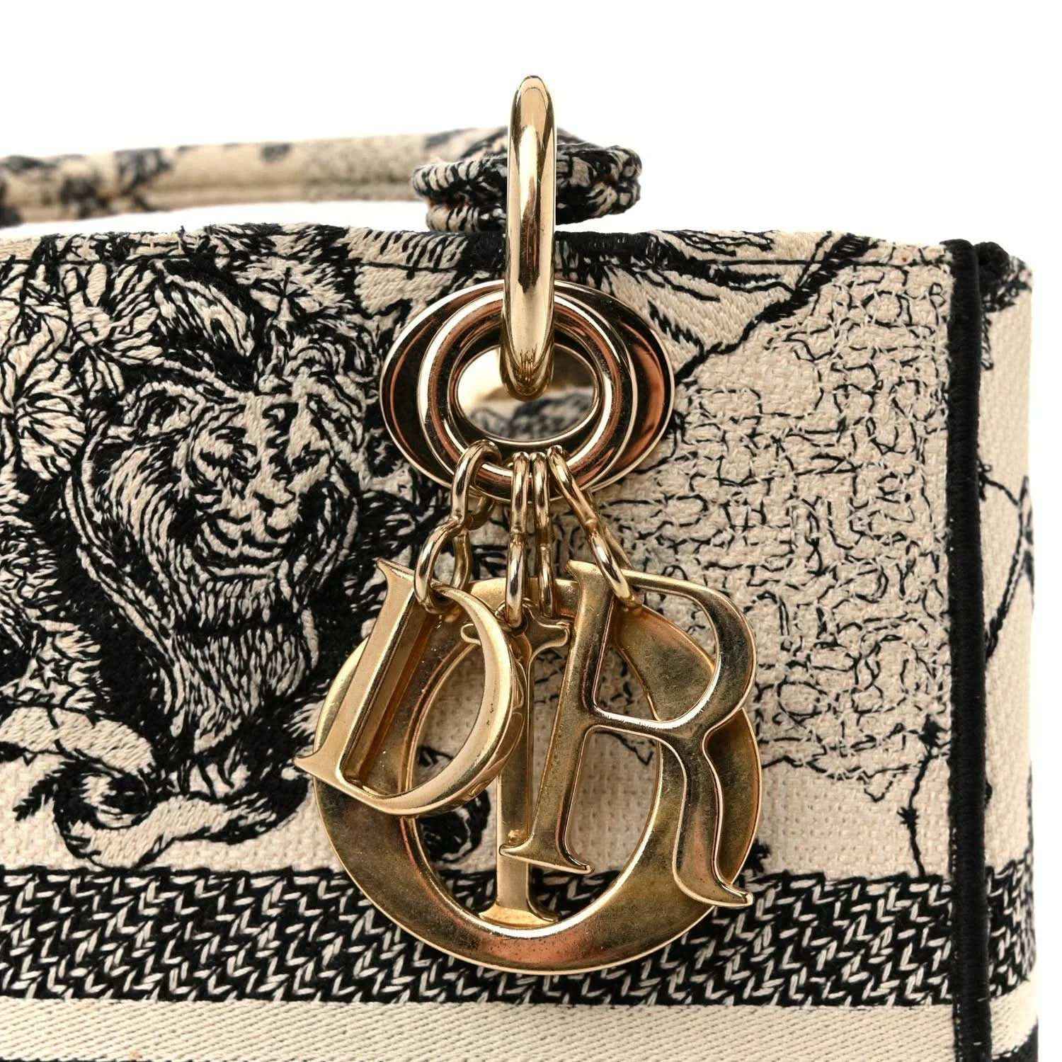 Medium handbag with gold-tone Dior charms on black-and-cream printed flap
