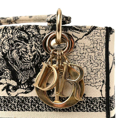 Medium handbag with gold-tone Dior charms on black-and-cream printed flap