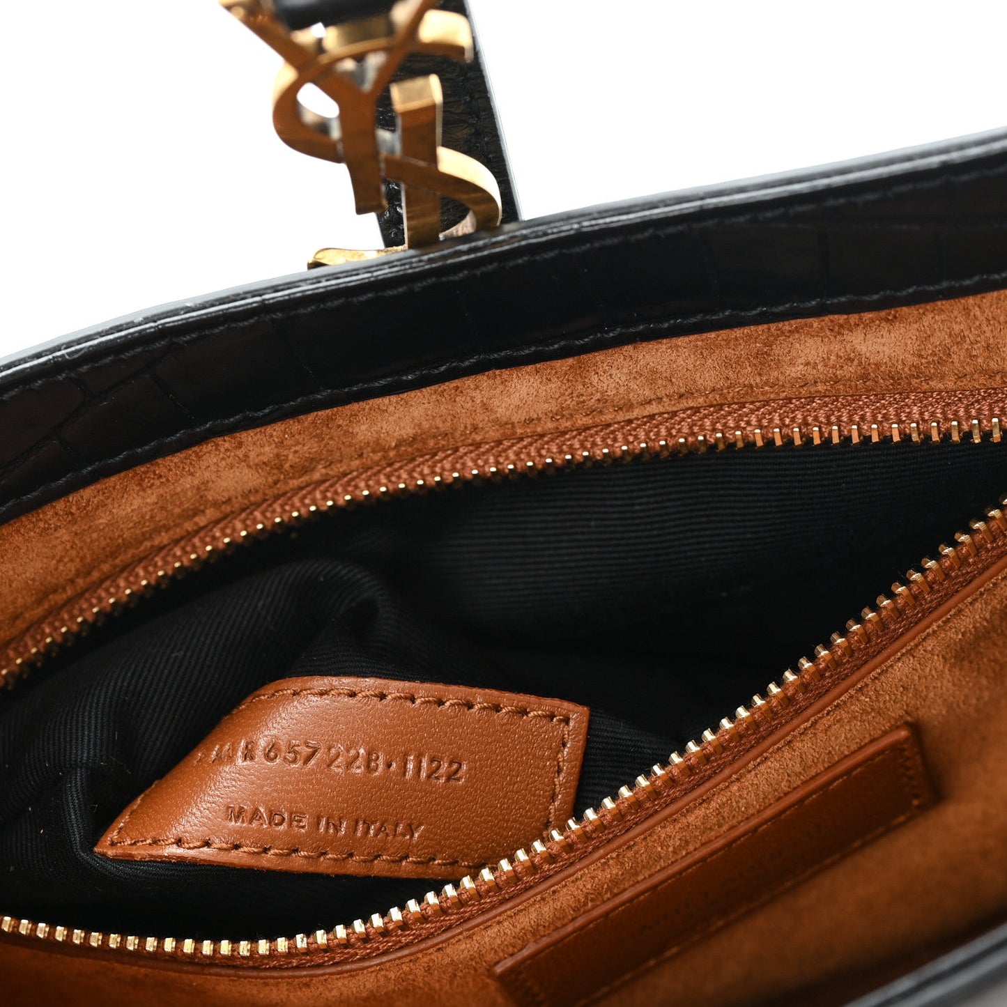 Brown leather interior with zippered compartment and stamped brand label