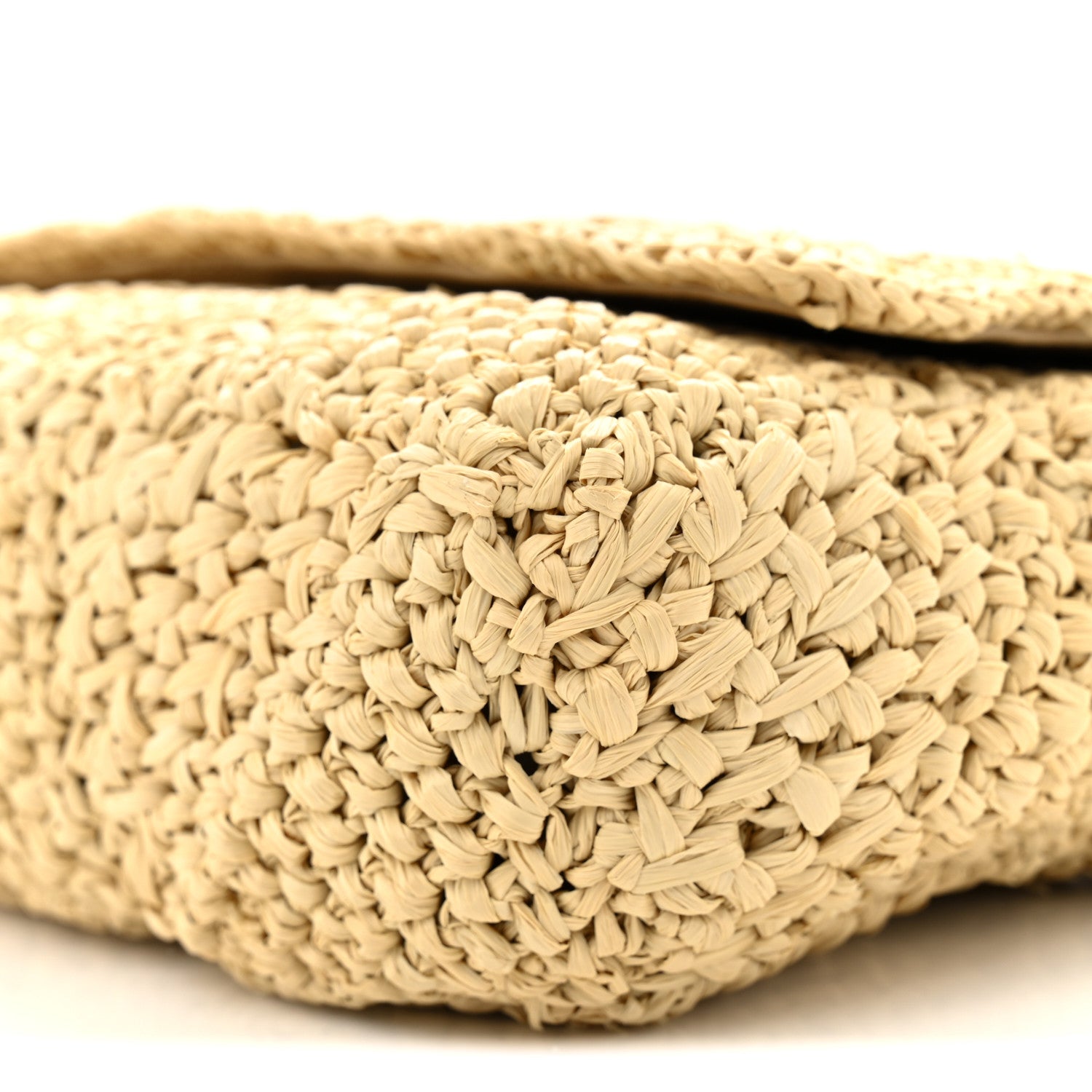 Natural raffia woven texture on shoulder bag exterior