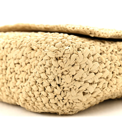 Natural raffia woven texture on shoulder bag exterior