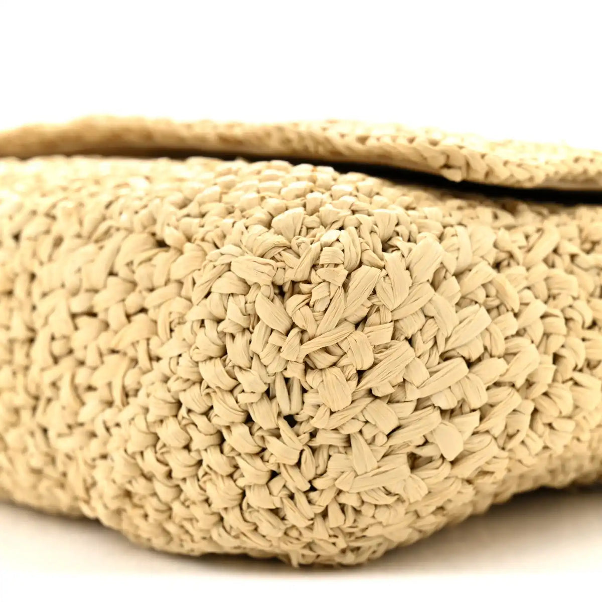 Natural raffia woven texture on shoulder bag exterior