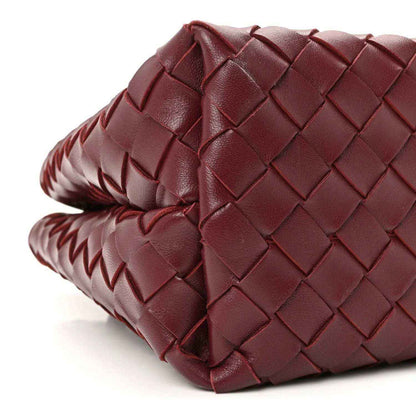 Burgundy intrecciato nappa leather bag, braided edge trim and side view.
