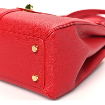 Celine small red bag with gold corner hardware and pebbled leather edge seam.