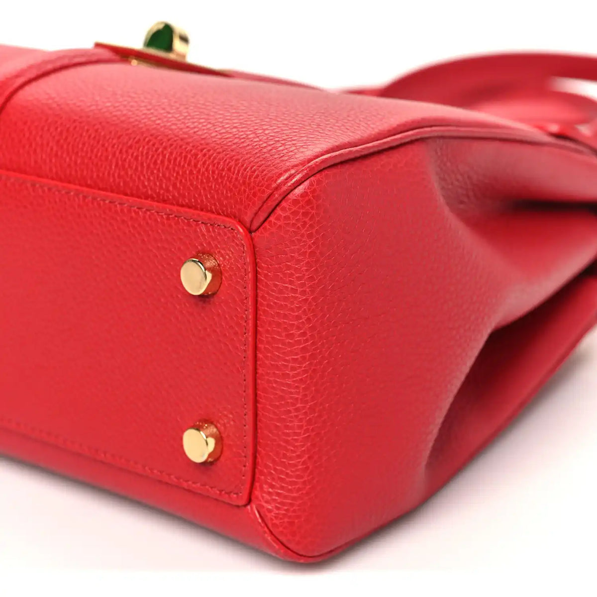 Celine small red bag with gold corner hardware and pebbled leather edge seam.