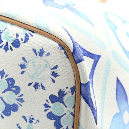 Blue and white monogram tote bag edge with tan leather trim and stitched seam