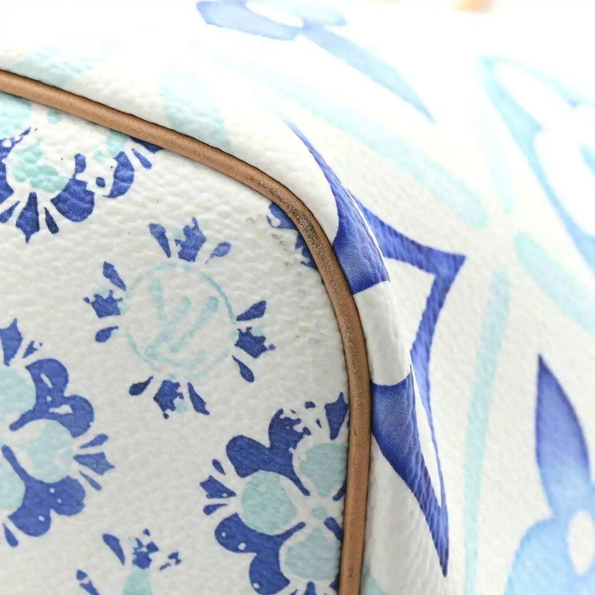Blue and white monogram tote bag edge with tan leather trim and stitched seam
