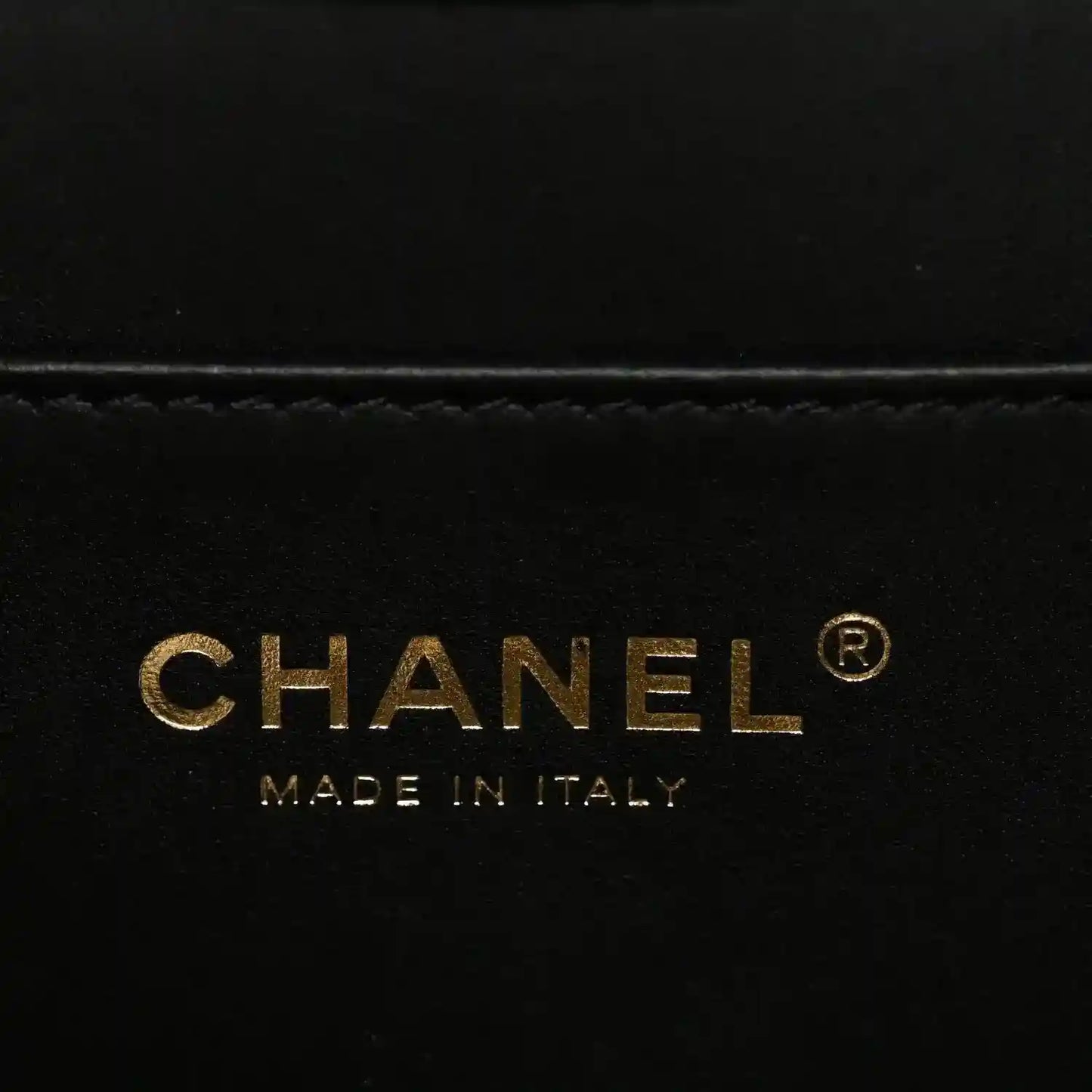 CHANEL label on black handbag lining with “MADE IN ITALY”