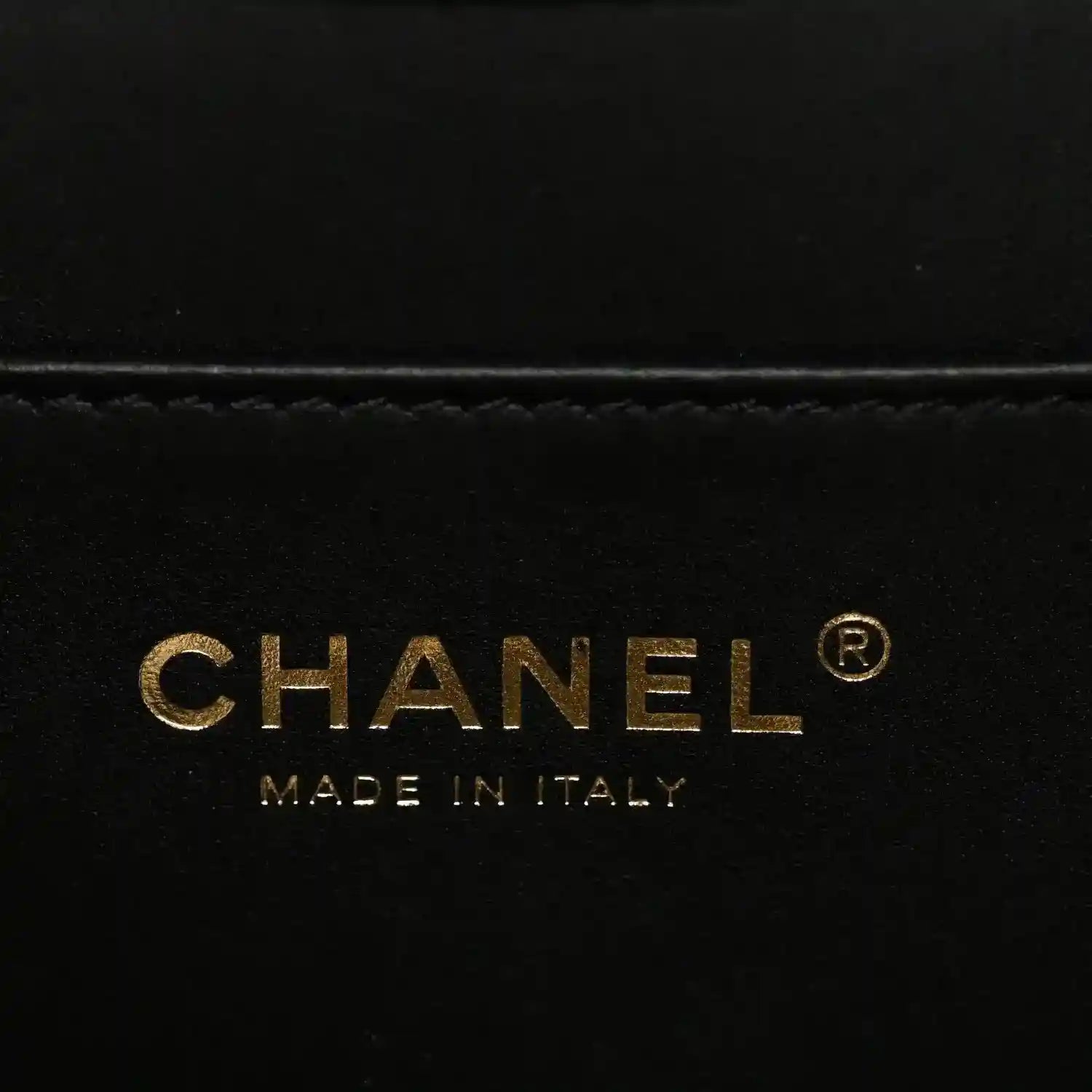 CHANEL label on black handbag lining with “MADE IN ITALY”