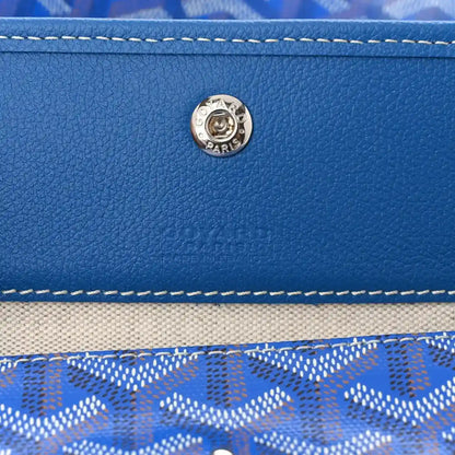 Sky blue leather trim with round metal clasp and double-row stitching on tote bag