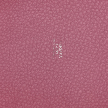 Rose pink textured leather panel with embossed brand lettering