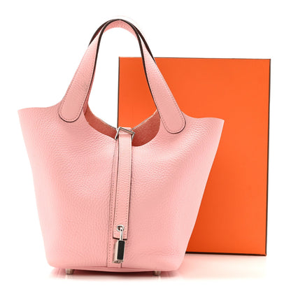 Rose pink leather tote handbag with top handles and front lock clasp