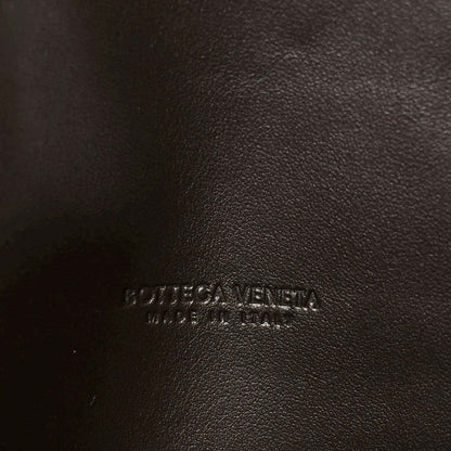 Embossed logo on dark leather clutch lining