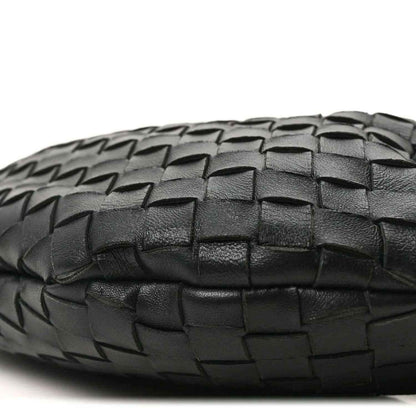 Bottega Veneta intrecciato nappa bag bottom in black with woven texture close-up.
