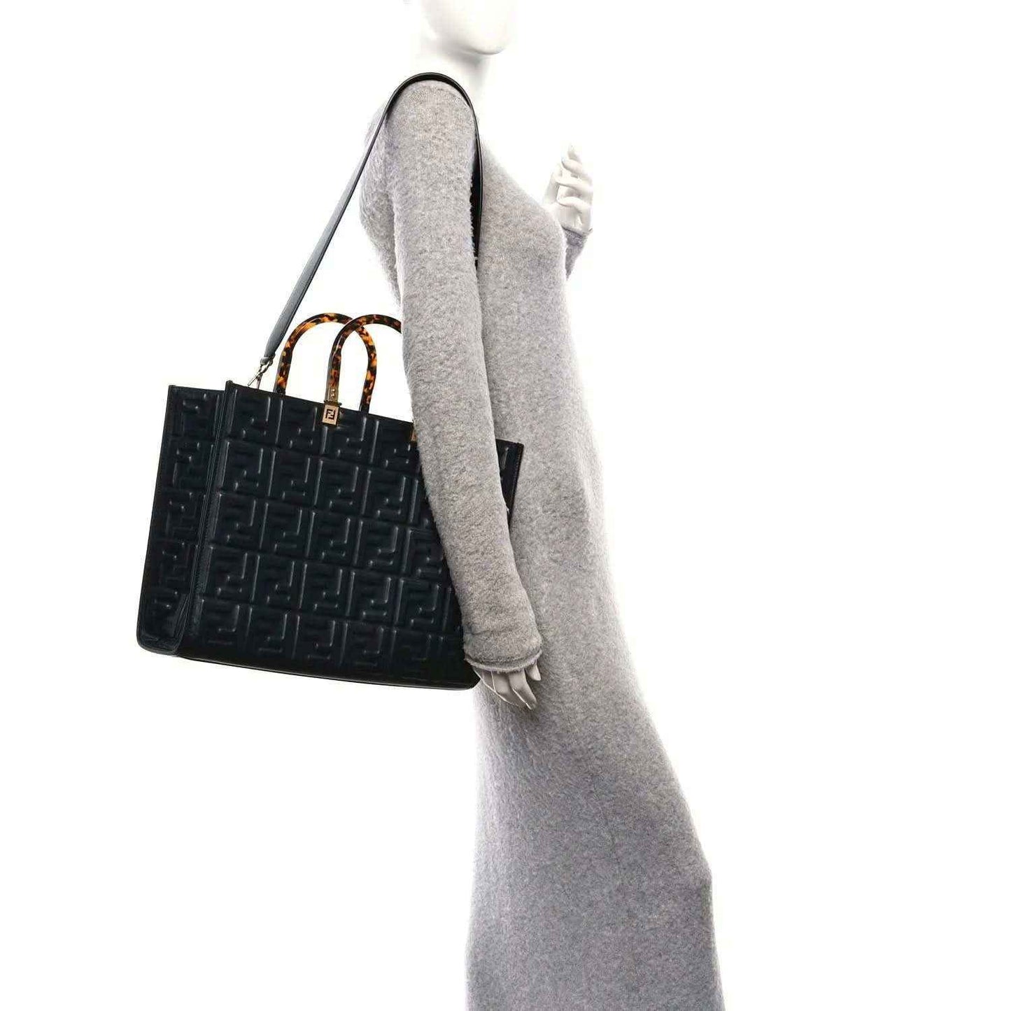 Black embossed leather tote bag with FF pattern and short top handles, viewed side