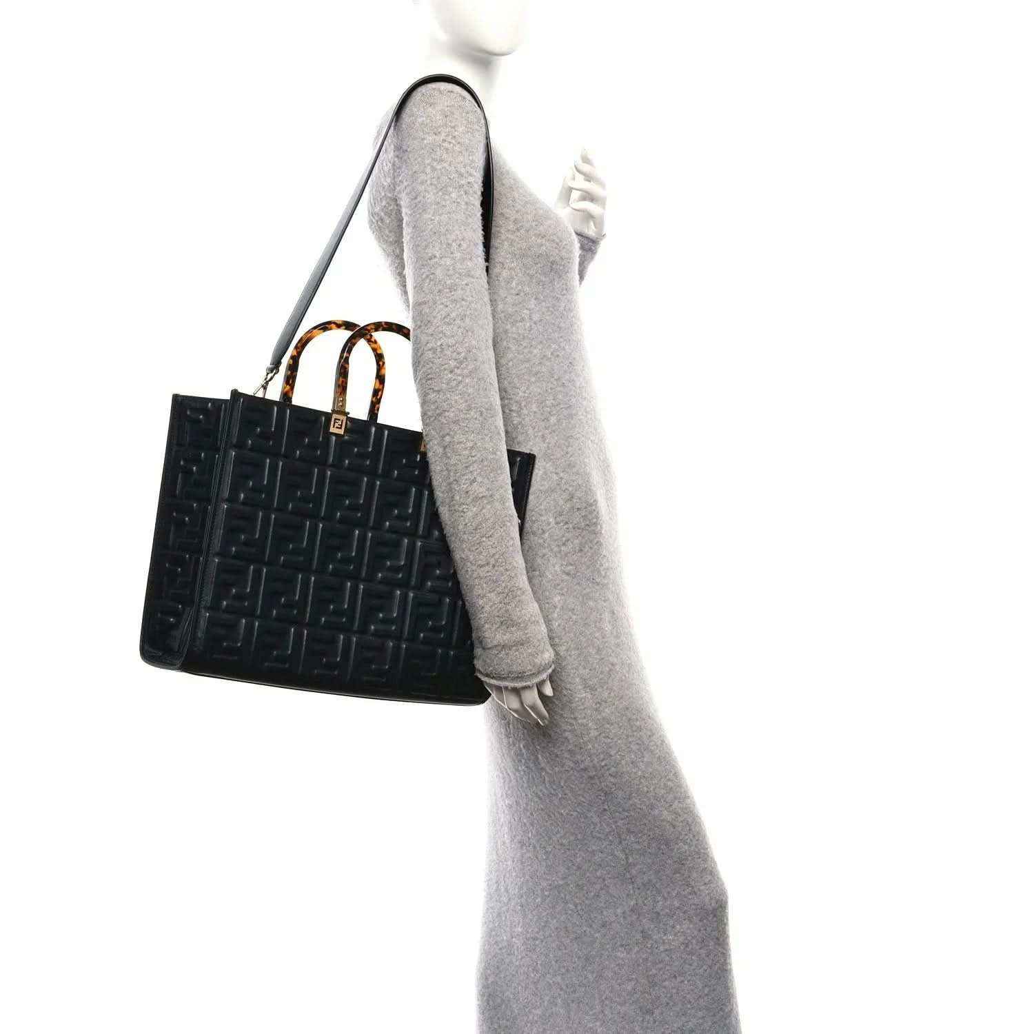 Black embossed leather tote bag with FF pattern and short top handles, viewed side
