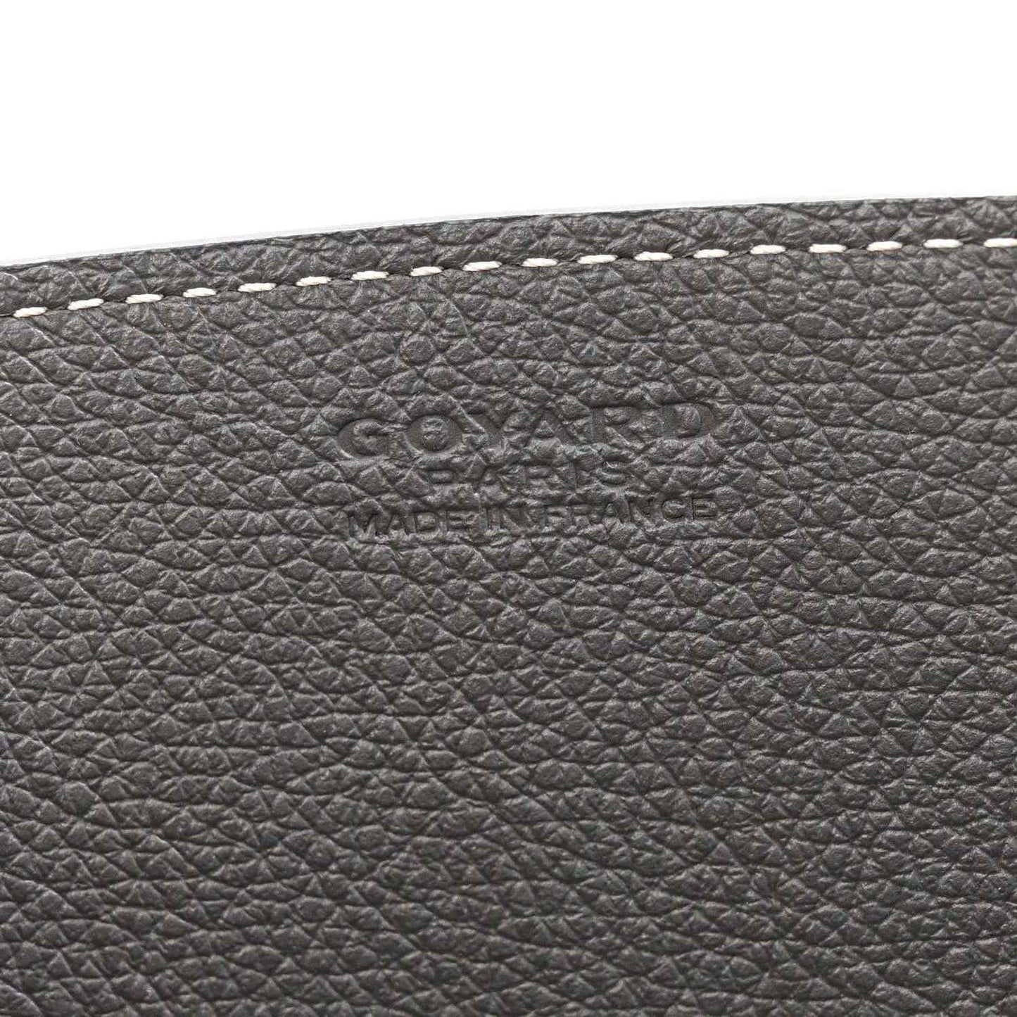 Grey leather exterior with embossed brand markings and fine-grain texture
