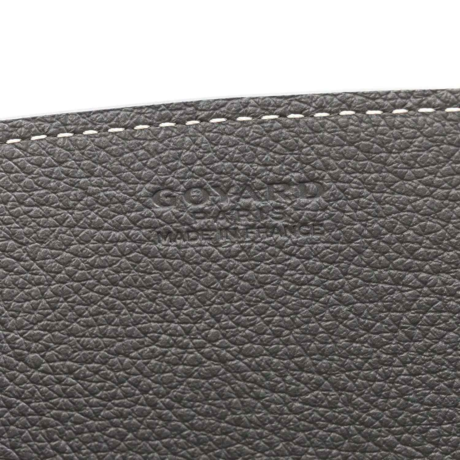 Grey leather exterior with embossed brand markings and fine-grain texture
