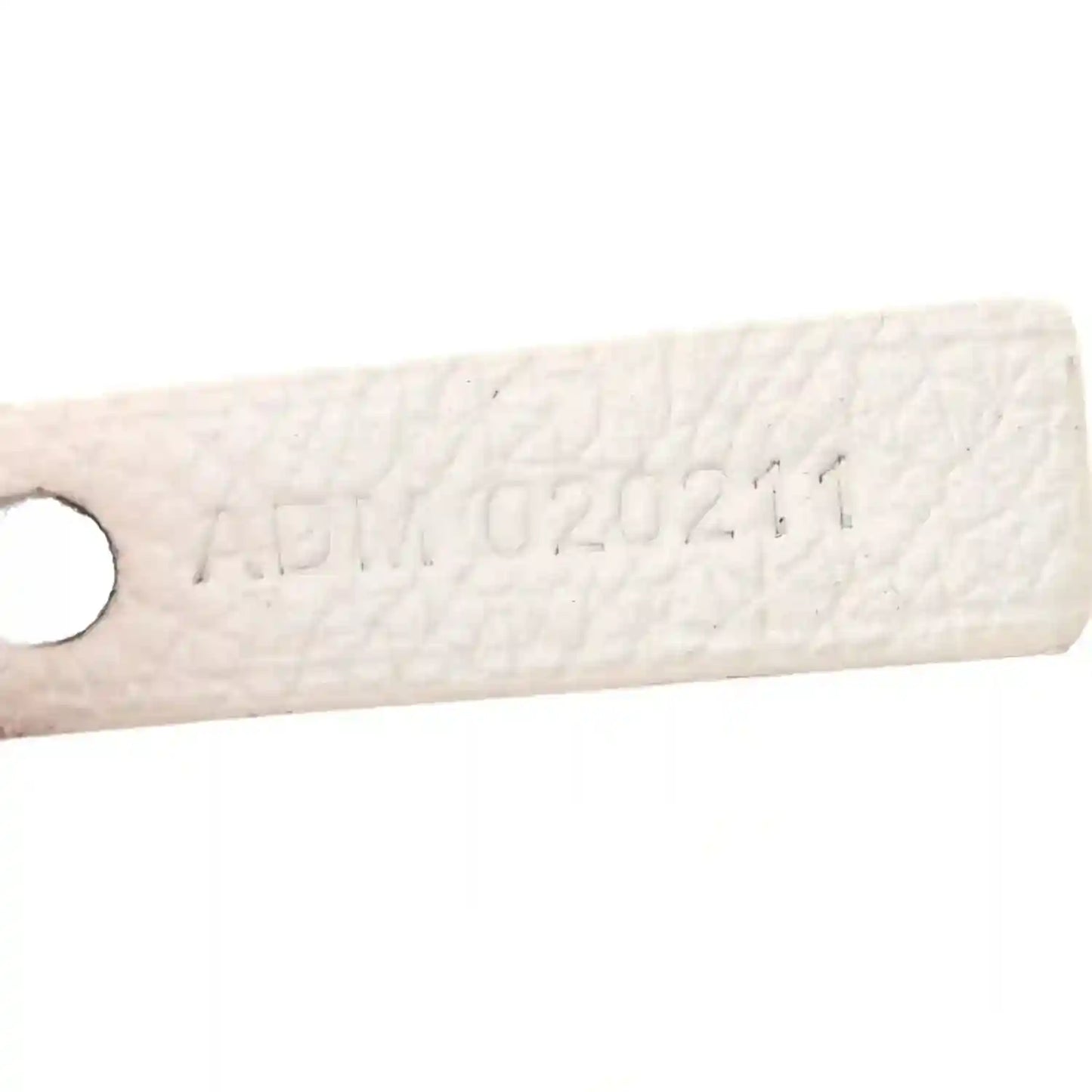 Goyard Saint Louis PM tote handle tab with embossed markings on white canvas