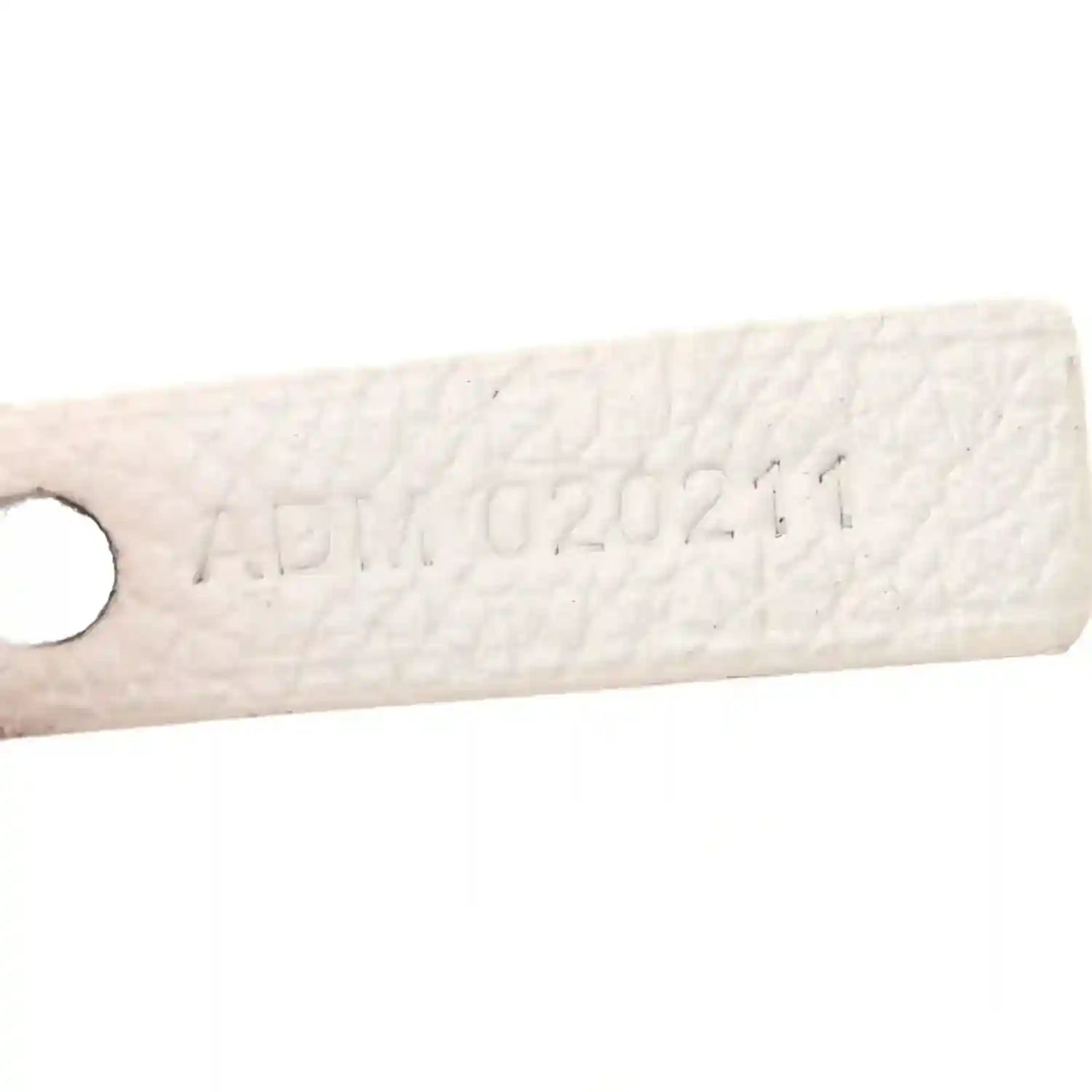 Goyard Saint Louis PM tote handle tab with embossed markings on white canvas