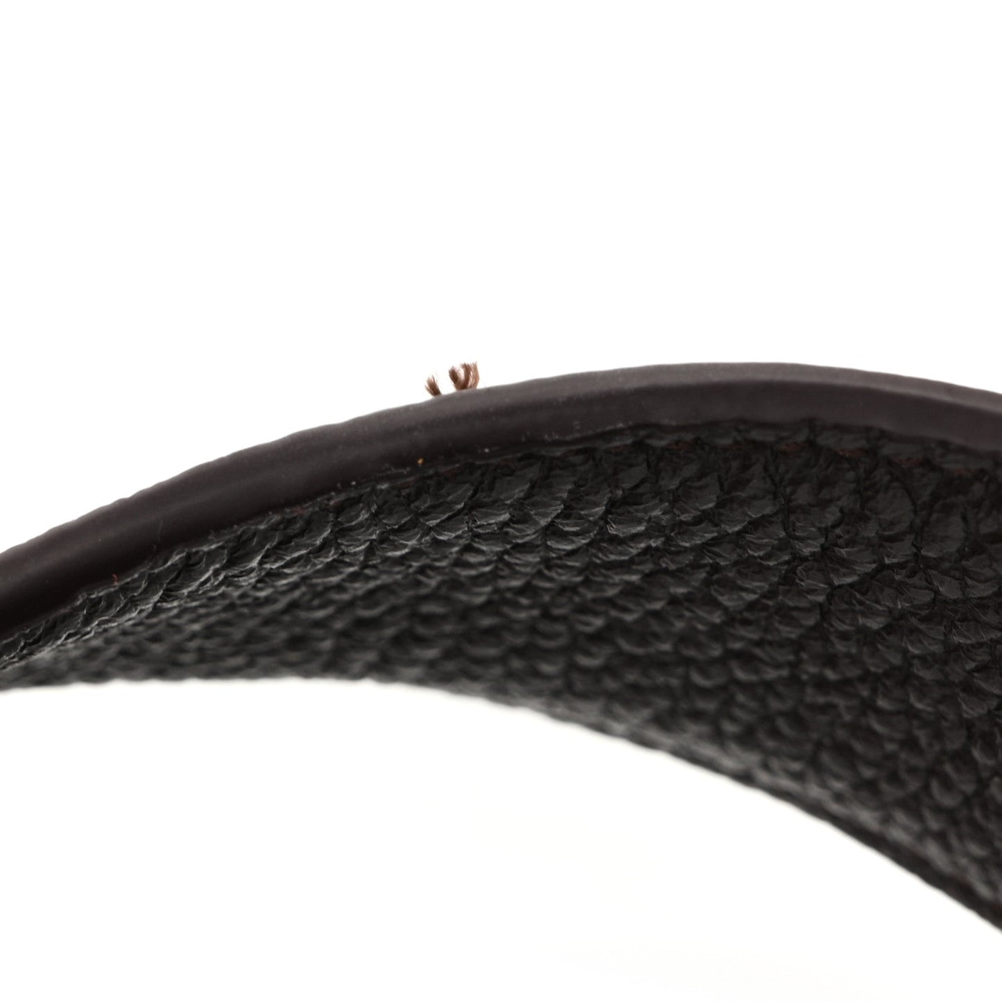 Grained deerskin tote handle in dark brown, pebbled texture and visible stitching