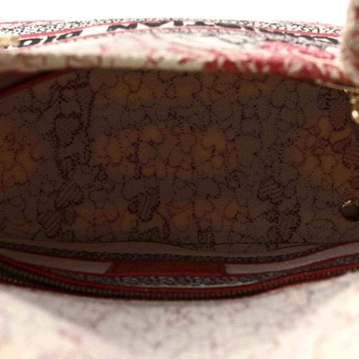 Handbag interior with brown lining and red-trimmed zipper edge visible
