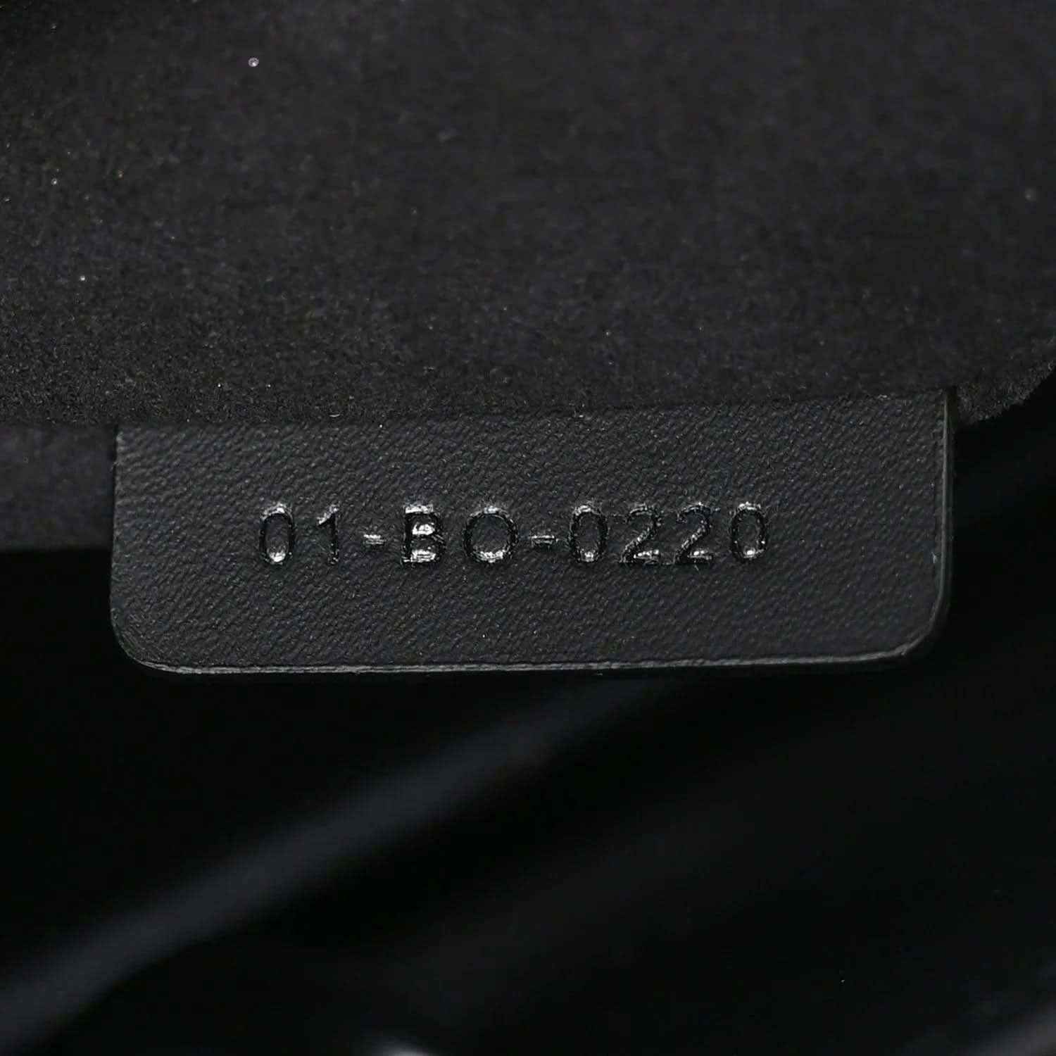 Black leather handbag tag with molded serial text
