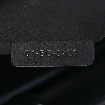Black leather handbag tag with molded serial text