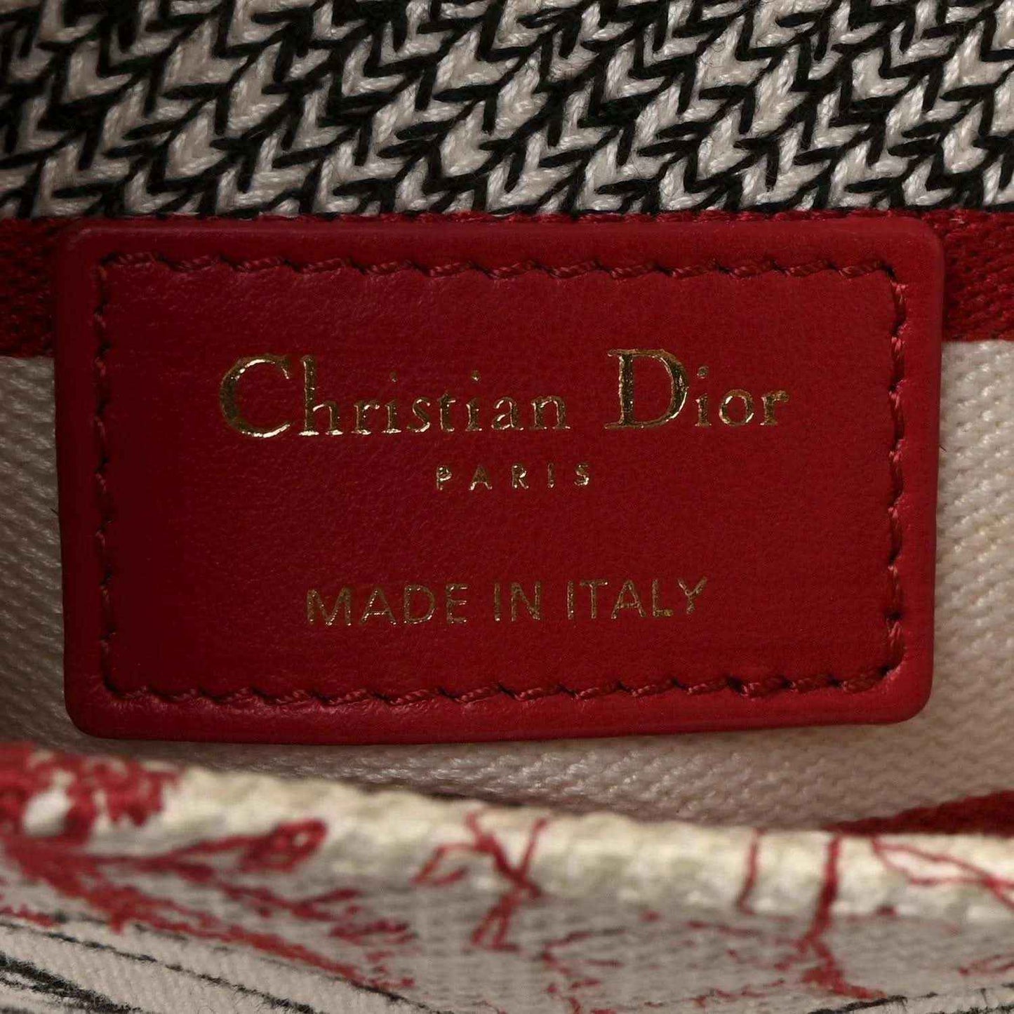Christian Dior label on handbag lining, red leather patch reading “MADE IN ITALY”