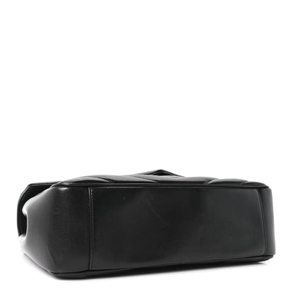 Black lambskin shoulder bag with quilted panels and top handle