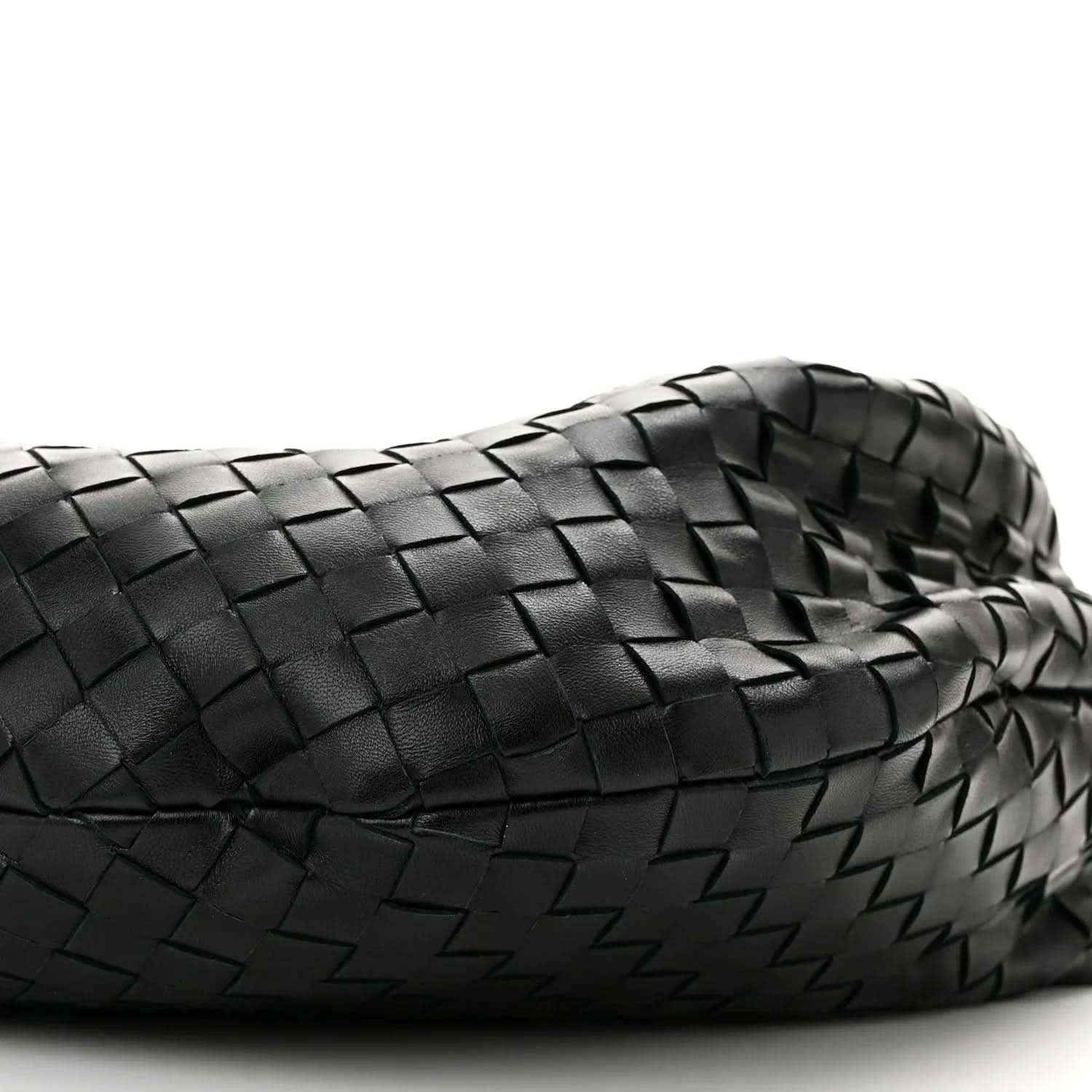 Black woven leather shoulder bag close-up with intrecciato texture