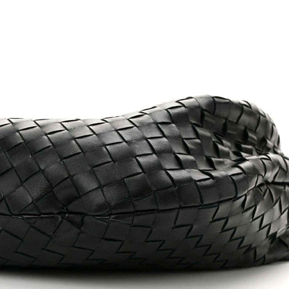 Black woven leather shoulder bag close-up with intrecciato texture