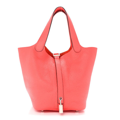 Pink leather tote bag with top handles and central lock clasp, open top
