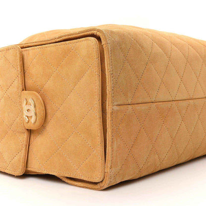 Chanel medium quilted suede handbag in classic beige, front flap with turnlock closure