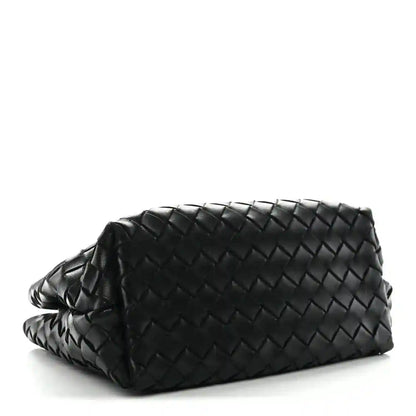 Black woven leather shoulder bag with braided strap and rounded top silhouette