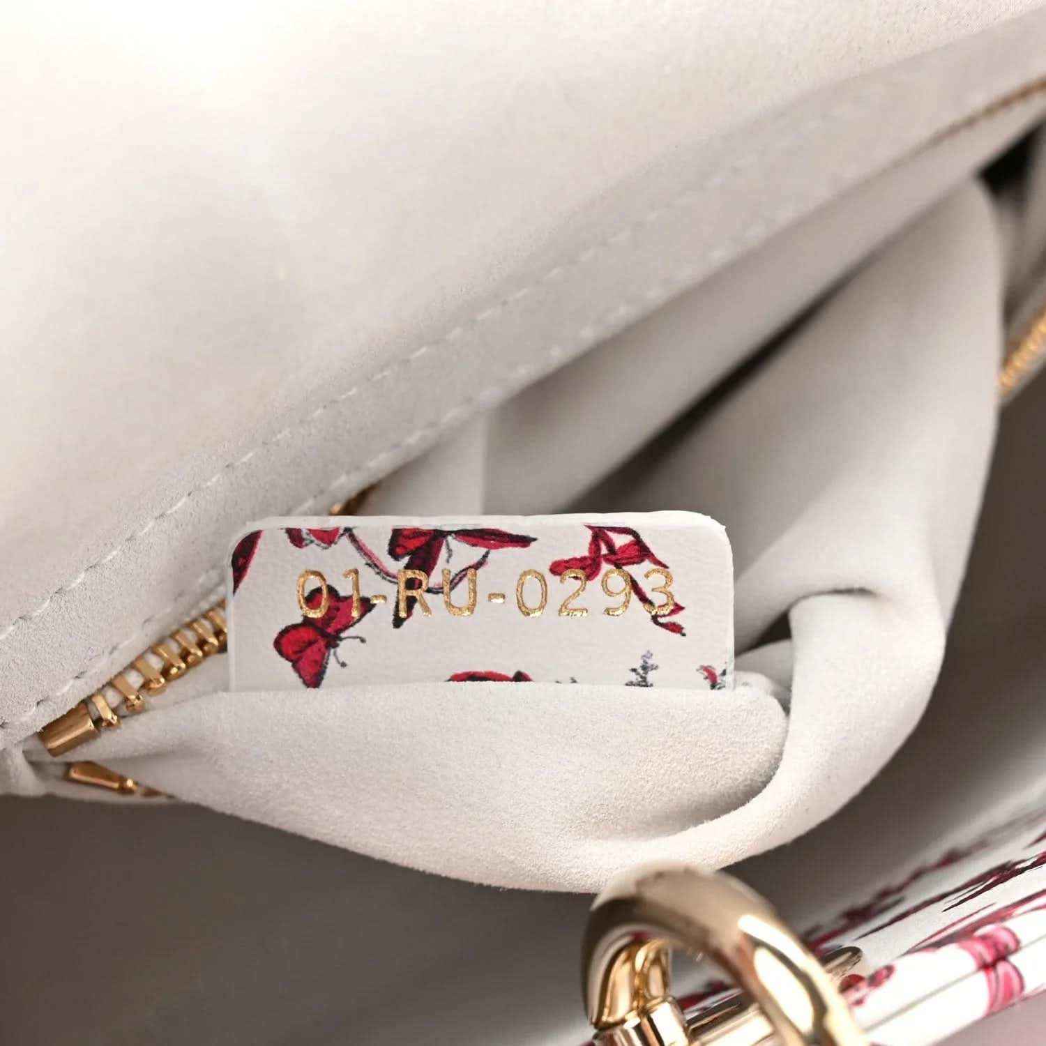 Handbag interior view with floral pocket lining and gold zipper hardware